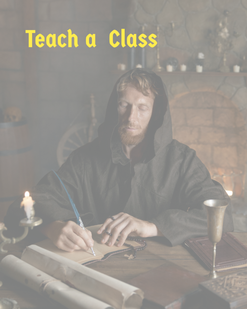 A man wearing a hooded medieval cloak sitting at a table writing on a scroll with a candle and goblet on the table. The words "Teach a Class" are across the top.